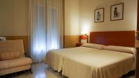 A bed or beds in a room at Hostal Forum
