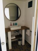 a bathroom with a sink and a mirror at Les Chambres d&#39;Hôtes de Bordustard in Le Palais