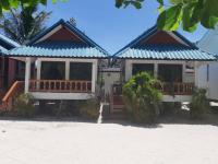 a house on the beach with a blue roof at Nice Sea Resort in Srithanu