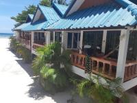 a house on the beach with a blue roof at Nice Sea Resort in Srithanu