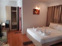 a bedroom with a large white bed with white pillows at Nice Sea Resort in Srithanu