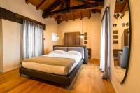 A bed or beds in a room at Relais San Vigilio al Castello