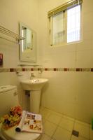 a white bathroom with a sink and a toilet at sweet home B&amp;B in Hualien City