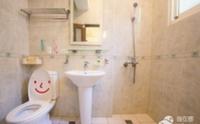 a bathroom with a toilet and a sink at sweet home B&amp;B in Hualien City