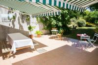 a patio with a table and chairs under an umbrella at Chambres d&#39;Hôtes Villa Bellevue in Albi