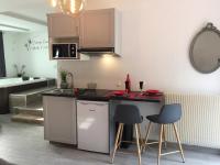 a kitchen with a counter and stools in a room at Suite Cupidon- Domaine des trois châteaux in Moisenay