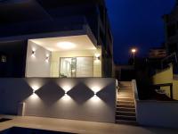 ein Haus mit Lichtern an der Wand in der Nacht in der Unterkunft Apartman Mateo in Njivice
