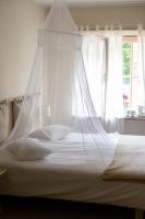 Postel nebo postele na pokoji v ubytování Kuursaal Guesthouse