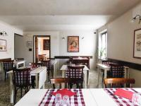 a dining room with tables and chairs in a restaurant at Trattoria Due Citroni in Casalgrasso