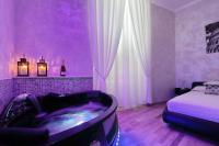 a purple room with a tub and a bed at Just Chilling Suite in Rome