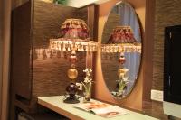 a dressing room with two lamps and a mirror at Spring Fountain Hotel in Jiaoxi