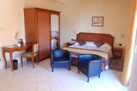 A bed or beds in a room at Grand Hotel Moroni
