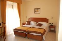 A bed or beds in a room at Grand Hotel Moroni