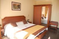 A bed or beds in a room at Grand Hotel Moroni