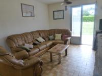 a living room with a leather couch and a coffee table at les volets bleus in Camaret-sur-Mer