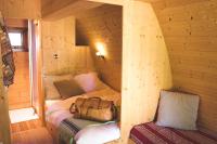 a room with a bed in a log cabin at L&#39;Escale des Châteaux de la Loire in Angé