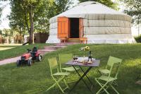 a table and chairs in front of a yurt at L&#39;Escale des Châteaux de la Loire in Angé