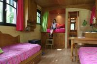 a woman sitting on a bed in a room at La Maison de l&#39;Omignon in Vermand