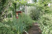 a path through a garden with plants and trees at La Maison de l&#39;Omignon in Vermand