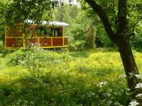 a yellow and red train in a field with a bench at La Maison de l&#39;Omignon in Vermand