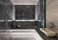 a black bathroom with a tub and a sink at Four Seasons Hotel George V Paris in Paris