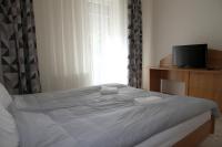 Posteľ alebo postele v izbe v ubytovaní Aqua City Apartman