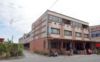 a building on the side of a street at Fish House Hostel in Wujie