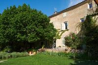 a large building with a tree and a yard at La Grande Maison De Nans in Nans-les-Pins