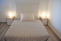 A bed or beds in a room at Recently refurbished apartment with sea views.