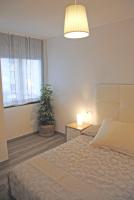 A bed or beds in a room at Recently refurbished apartment with sea views.