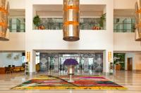 a lobby with a fireplace with a flower vase on the floor at Canal Central Hotel Business Bay in Dubai