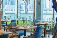 a row of tables and chairs in a restaurant at Canal Central Hotel Business Bay in Dubai