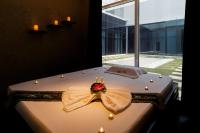 a bed with a flower on it with a window at Canal Central Hotel Business Bay in Dubai
