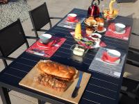 a blue table with a breakfast of bread and fruit at Audionnière in Saint-Gervais en-Belin