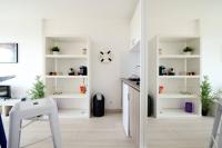 a kitchen with white shelves and a table at Sea Swing and Sun in La Ciotat