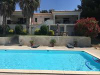 a swimming pool in front of a house at Le Gîte du DAB in La Cadière-dʼAzur