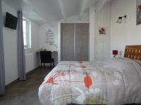 a bedroom with a bed and a desk in it at Chambres d&#39;hôtes - Chez Stephane in L&#39;Ile d&#39;Yeu