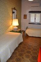 A bed or beds in a room at B&B VILLA LUPIDI