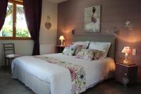 a bedroom with a large white bed with pillows at Gîte d&#39;Anne et Ulysse in Sept-Frères