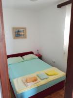 Posteľ alebo postele v izbe v ubytovaní Apartmani Rosanda