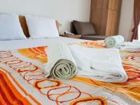 a bed with blankets and pillows on it at Villa Bube in Trpejca