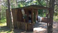 a small wooden out house in the woods at La Ptite Ferme de Caro in Meyrignac-lʼÉglise