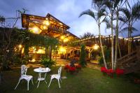 a table and chairs in front of a house at night at Country Grange B&amp;B in Yuanshan