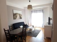 a living room with a table and a couch and a dining room at le mauritania in Sainte-Maxime