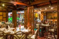 a restaurant with tables and chairs in a room at Mövenpick Grand Al Bustan in Dubai