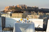 a table and chairs with a view of the city at Titania Hotel in Athens