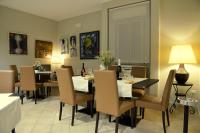 a dining room with a table and chairs with wine bottles at Albergo Italia in Porto Tolle
