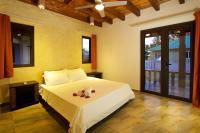 a bedroom with a bed with two stuffed animals on it at Villa Sole in Anse Volbert Village