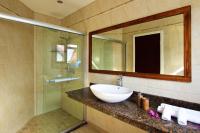 a bathroom with a sink and a mirror and a shower at Villa Sole in Anse Volbert Village