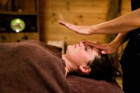 a woman getting a head massage from a therapist at Chalet-Hôtel La Marmotte, La Tapiaz &amp; SPA, The Originals Relais (Hotel-Chalet de Tradition) in Les Gets